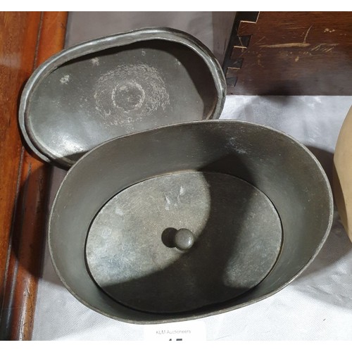 15 - A Georgian pewter tea caddy of oval form with internal press, width 5.25