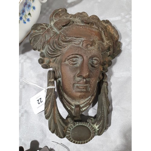 22 - A brass door knocker in the form of Bacchus, length 7