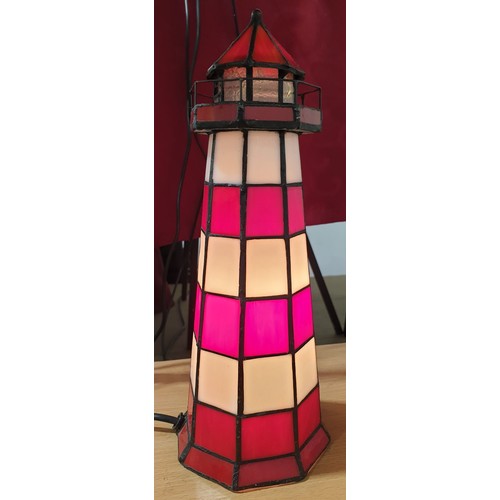 117 - A Tiffany style table lamp in the form of a lighthouse with diming function, height 11.25