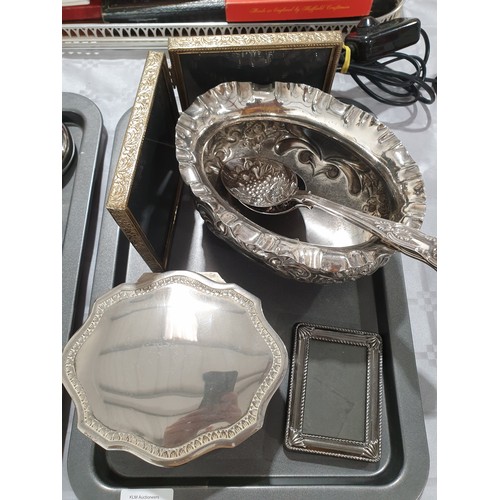 119 - A silver plated bowl, two silver plated berry spoons, a silver plated jewellery box and photo frames... 