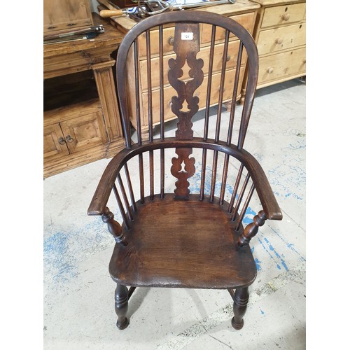 124 - An antique elm Windsor armchair. No shipping. Arrange your own packer and shipper, please.