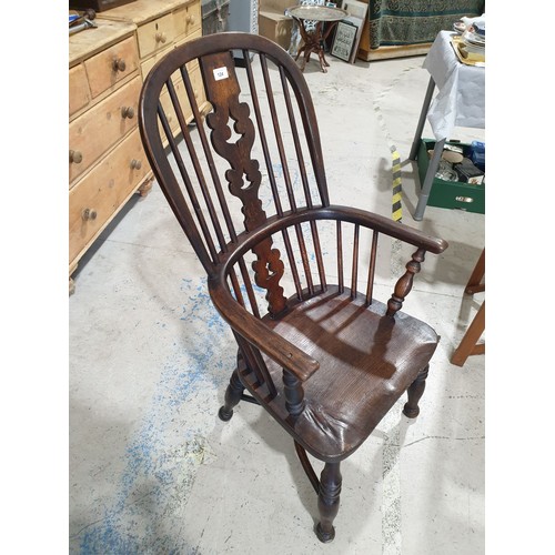 124 - An antique elm Windsor armchair. No shipping. Arrange your own packer and shipper, please.