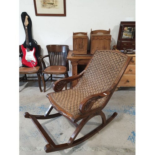 128 - A large hardwood and wicker carved rocking chair. No shipping. Arrange your own packer and shipper, ... 