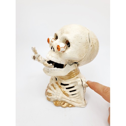 198 - A cast iron skeleton money box, height 6.5