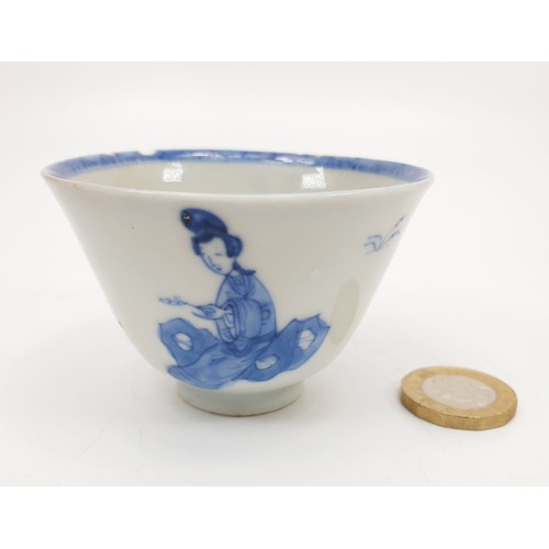 201 - A Chinese Ming style cup decorated in blue and white with figures and trees, conch shell on the inte... 