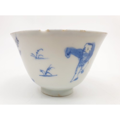 201 - A Chinese Ming style cup decorated in blue and white with figures and trees, conch shell on the inte... 