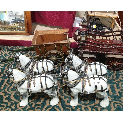 219 - Four Beswick shire horses with tack and two carts, horse's height 8.5