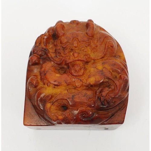 284 - An antique Chinese jade belt hook carved with a dragon, width 1.75