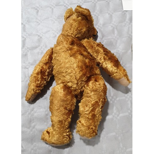 450 - A vintage straw filled articulated teddy bear, length 18