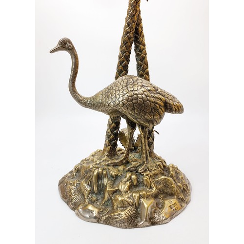 451 - An antique silver plated table centre piece modelled as an Ostrich beside palm trees with a cut glas... 