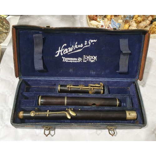 452 - An antique Hawkes & Son of London wooden flute with case and book. UK shipping £14.