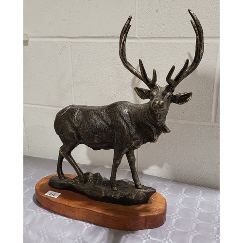 214 - A cast iron model of an elk on a wooden base, height 18.5