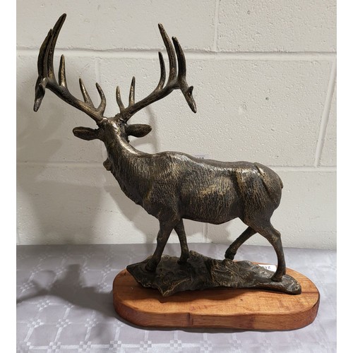 214 - A cast iron model of an elk on a wooden base, height 18.5