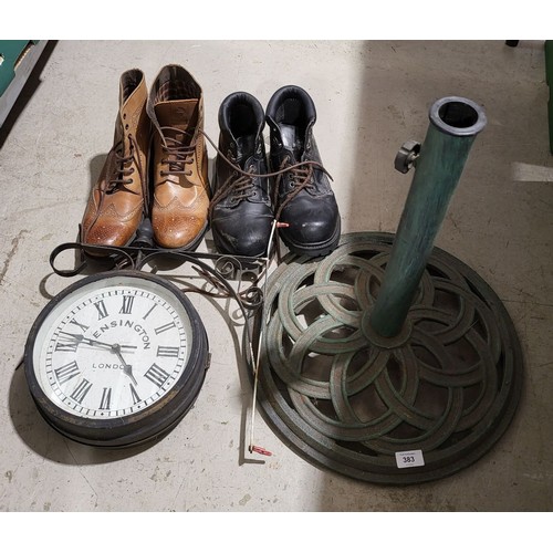 383 - A cast iron garden parasol base, an outdoor clock and two pairs of work boots. No shipping. Arrange ... 