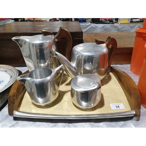 34 - A four piece Picquot ware tea set together with tray. No shipping. Arrange collection or your own pa... 