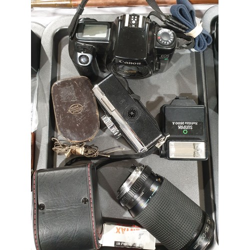 89 - A Canon EOS 1000 camera body together with other cameras and camera accessories. UK shipping £14.