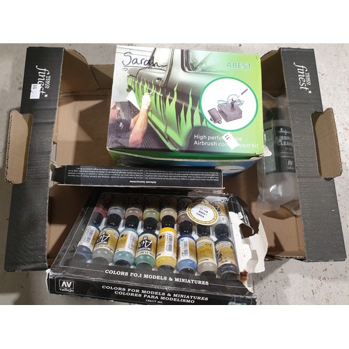 110 - An air brush and paints. UK shipping £14.