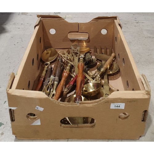 144 - A box of brass utensils. UK shipping £14.