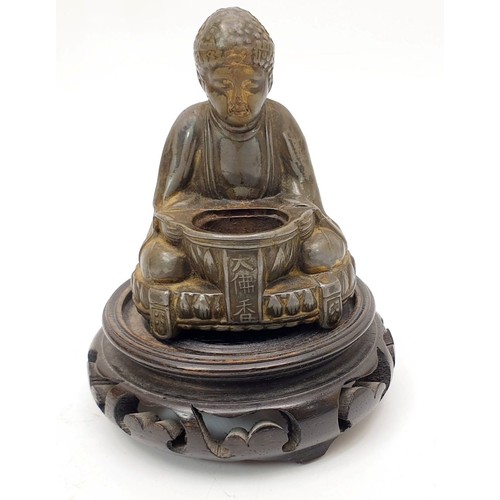 197 - A vintage Japanese spelter figure of Buddha with a hardwood stand, height 4.5