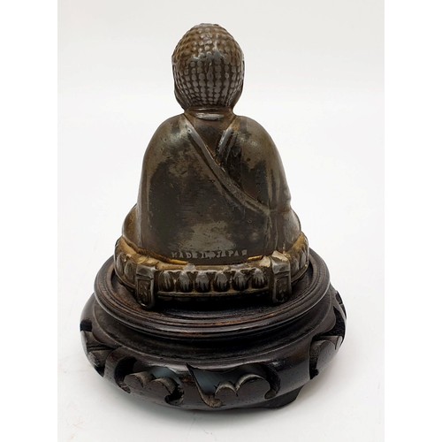 197 - A vintage Japanese spelter figure of Buddha with a hardwood stand, height 4.5