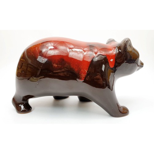 199 - A Canadian Blue Mountain model of a bear finished in red glaze, length 10