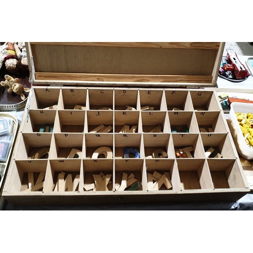 463 - A box containing wooden letters, width 30.25