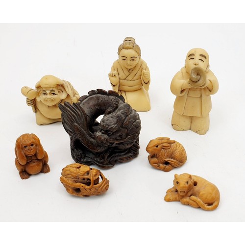 338 - A selection of hard stone and wooden netsuke and a wooden carving, the tallest 2