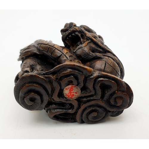 338 - A selection of hard stone and wooden netsuke and a wooden carving, the tallest 2