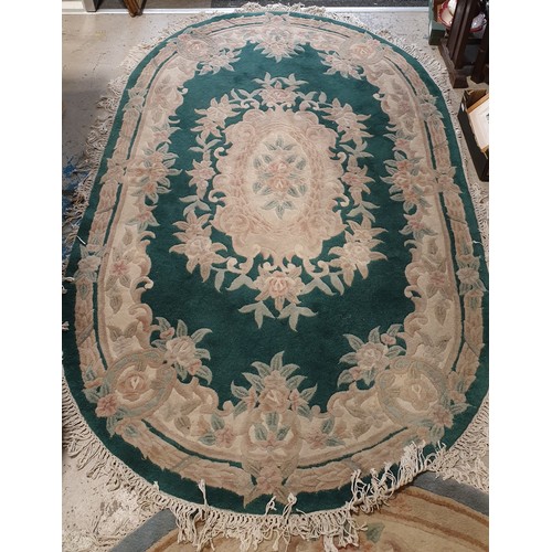 332 - A Chinese green woollen rug, length 100