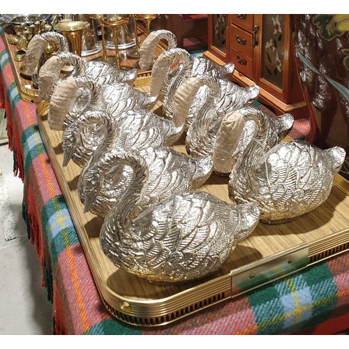 212 - Nine metal swan ornaments, height 6.25