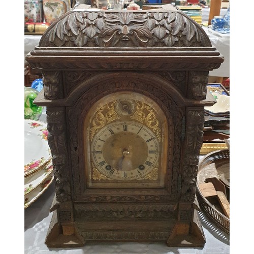 6 - An antique heavily carved oak mantel clock A/F, height 18