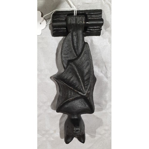 23 - A cast iron door knocker in the form of a bat, length 7