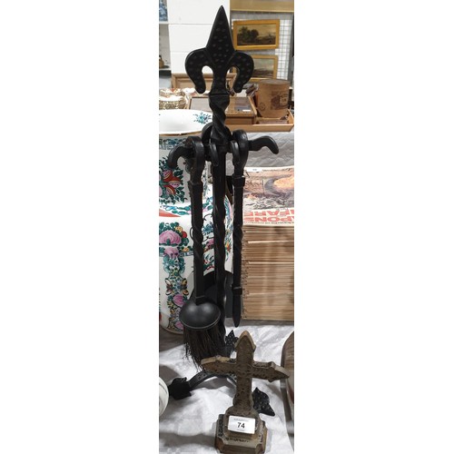 74 - A wrought iron companion set and a cast iron door stop. No shipping. Arrange collection or your own ... 