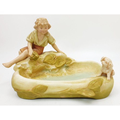 247 - A Royal Dux figure of a boy and his dog beside a pool, length 9.25