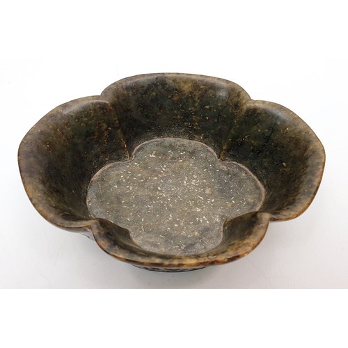 324 - A Chinese hard stone dish with carved panels bearing Buddhist emblems, length 5.5