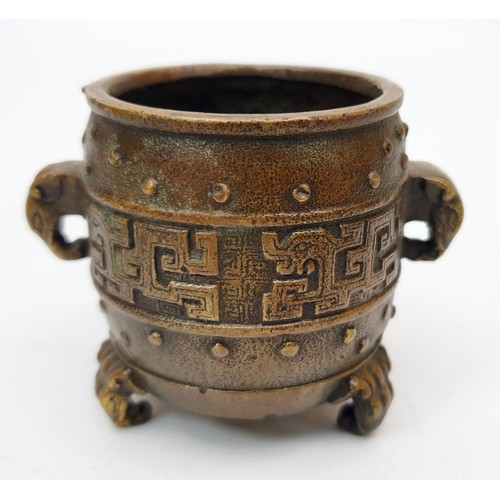 325 - An antique Chinese bronze censor with elephant handles, tripod feet and four character reign mark fo... 