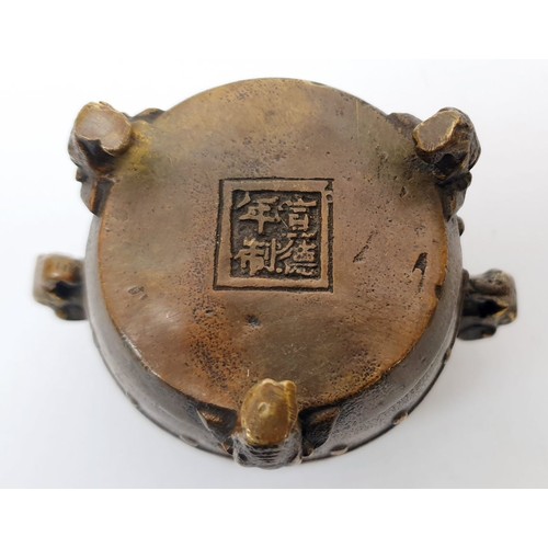 325 - An antique Chinese bronze censor with elephant handles, tripod feet and four character reign mark fo... 