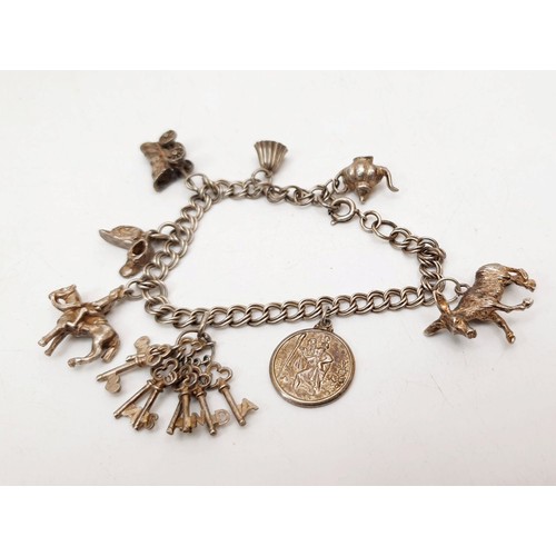 358 - A silver charm bracelet, weight 30g. UK shipping £14.