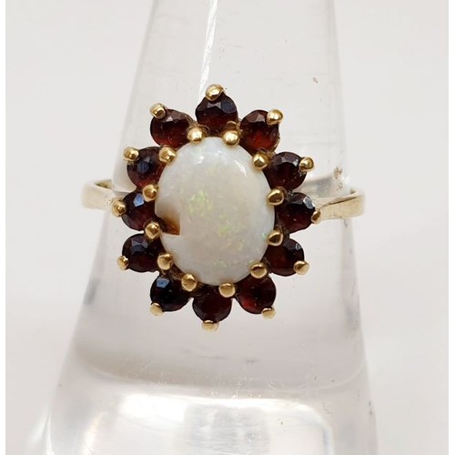 371 - A hallmarked 9ct gold cluster ring set with an opal and red stones, size P/Q, A/F, weight 2.5g. UK s... 