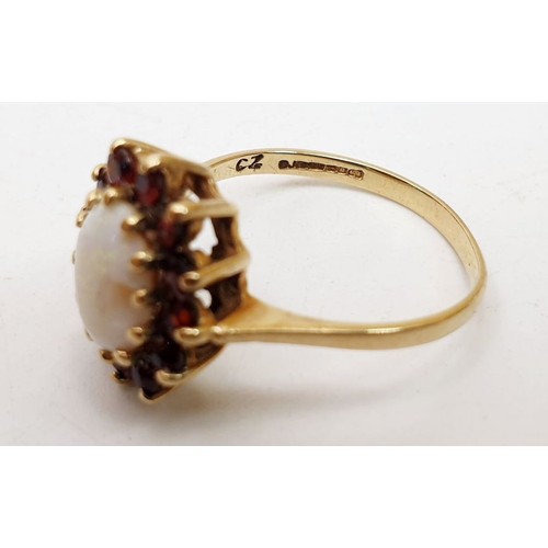 371 - A hallmarked 9ct gold cluster ring set with an opal and red stones, size P/Q, A/F, weight 2.5g. UK s... 