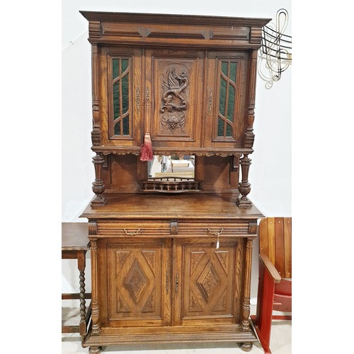 288 - An early 20th century oak sideboard with cupboard under, mirrored back and cupboard above with a car... 