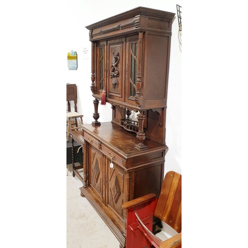 288 - An early 20th century oak sideboard with cupboard under, mirrored back and cupboard above with a car... 