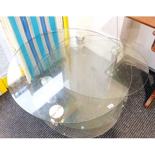 313 - A Dwell extending glass coffee table, diameter 35.5