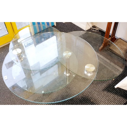 313 - A Dwell extending glass coffee table, diameter 35.5