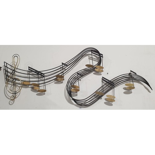 319 - A metal musical notes wall decoration, signed and dated 1988, length 61