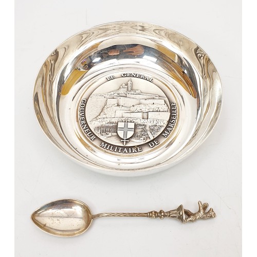 412 - An 800 silver spoon together with a silver plated French military presentation dish, diameter 4.25