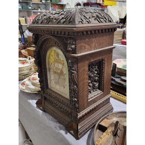 6 - An antique heavily carved oak mantel clock A/F, height 18