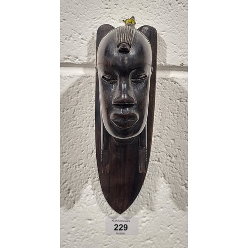 229 - An ironwood tribal wall carving, length 8.5