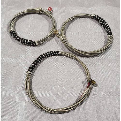 421 - Three bracelets made from guitar strings. UK shipping £14.