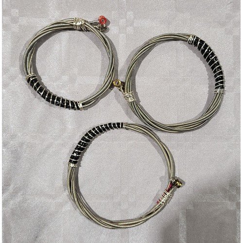 421 - Three bracelets made from guitar strings. UK shipping £14.